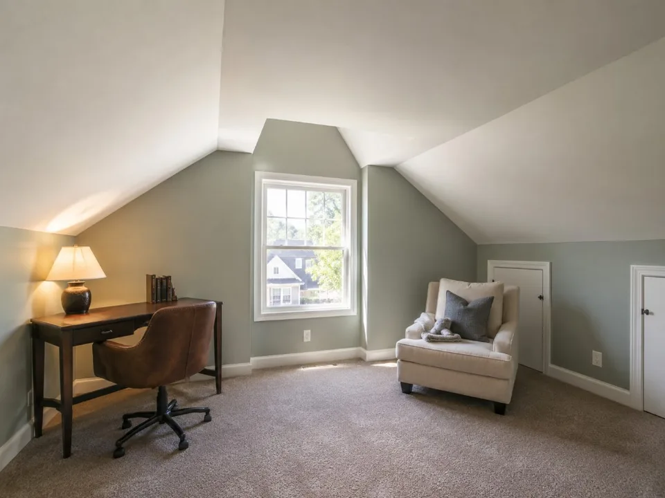 Finished bonus room with reconstructed drywall, painting, and trim.